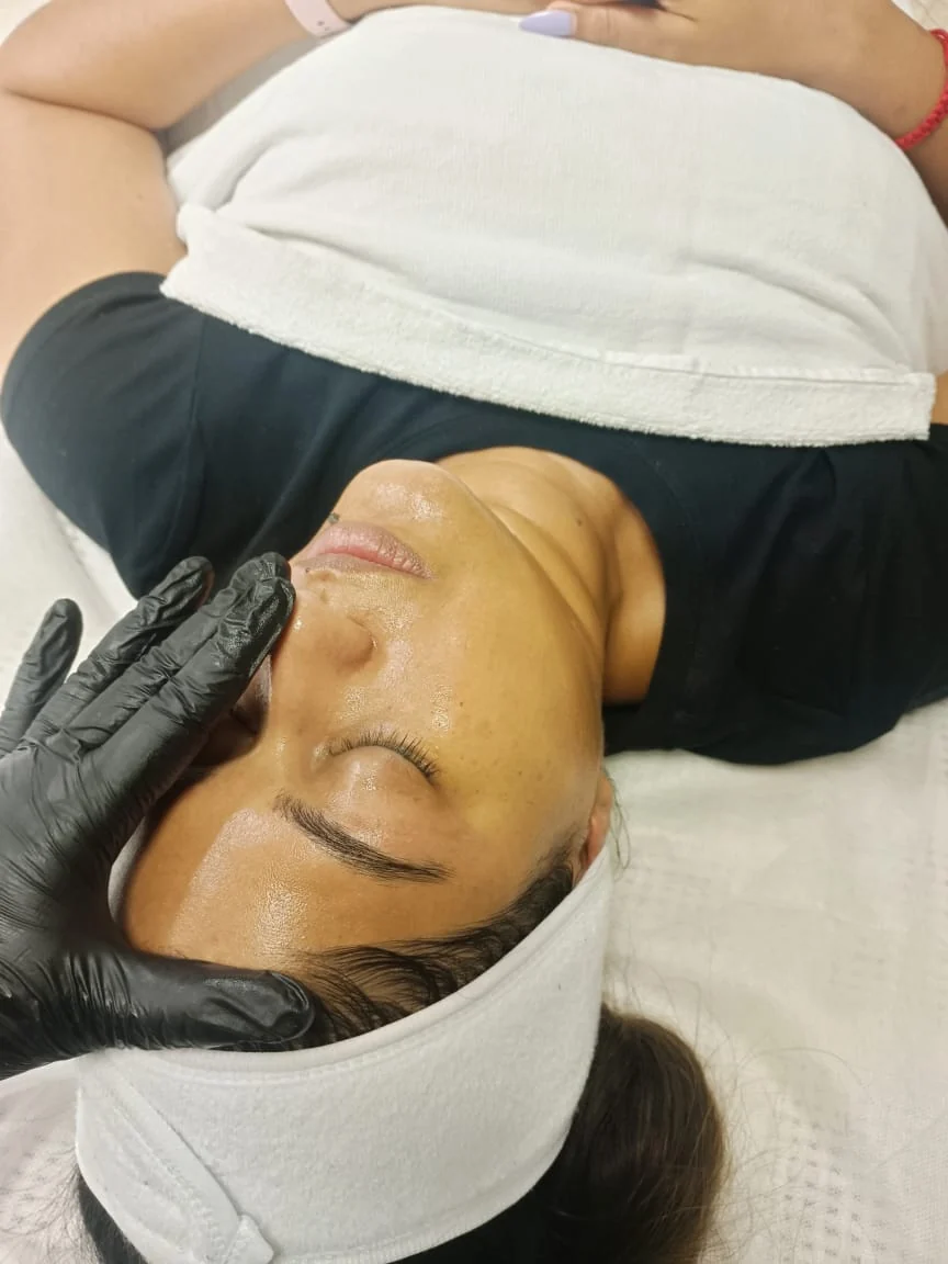 A client receiving a facial treatment at Waxbae